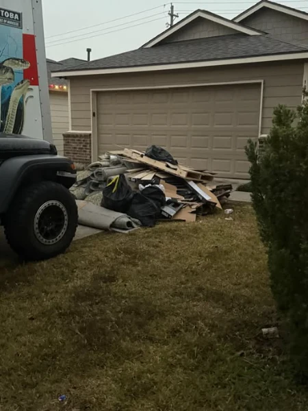 Pile of junk and debris outside a garage ready for junk removal in Lubbock, Texas