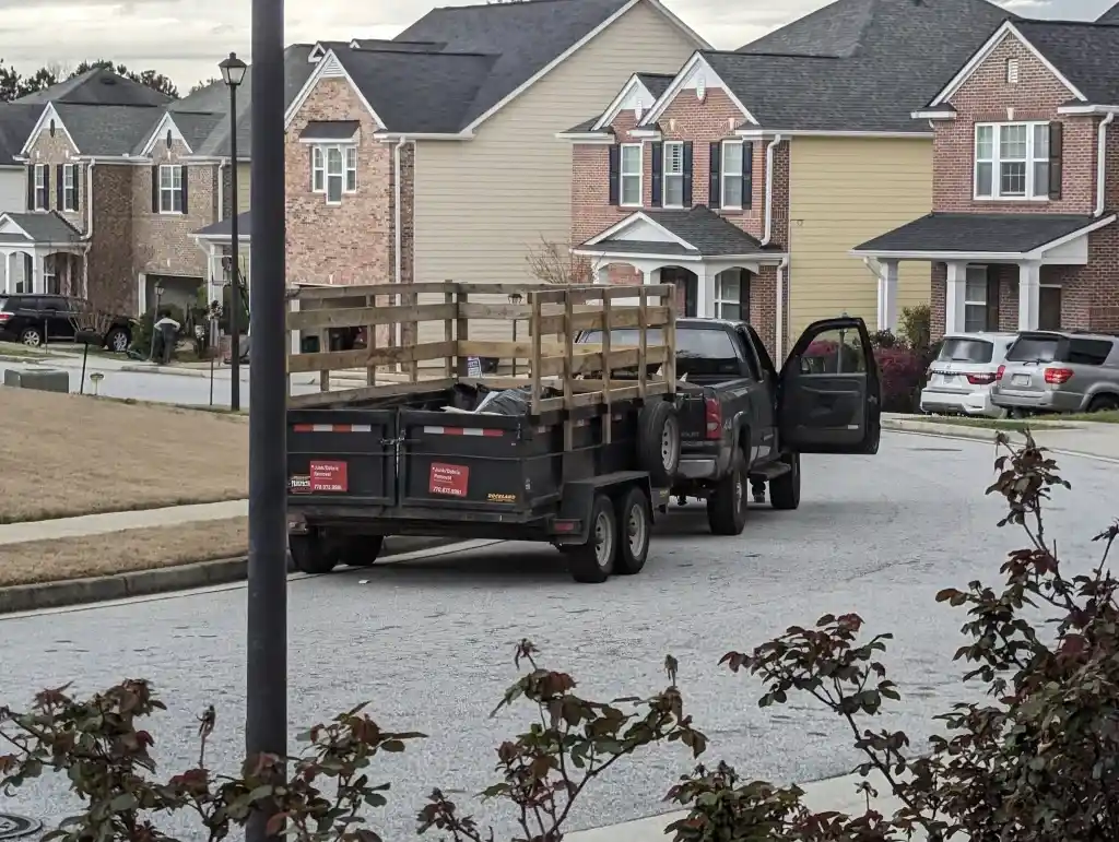 Local junk hauling truck with trailer in a Lubbock neighborhood
