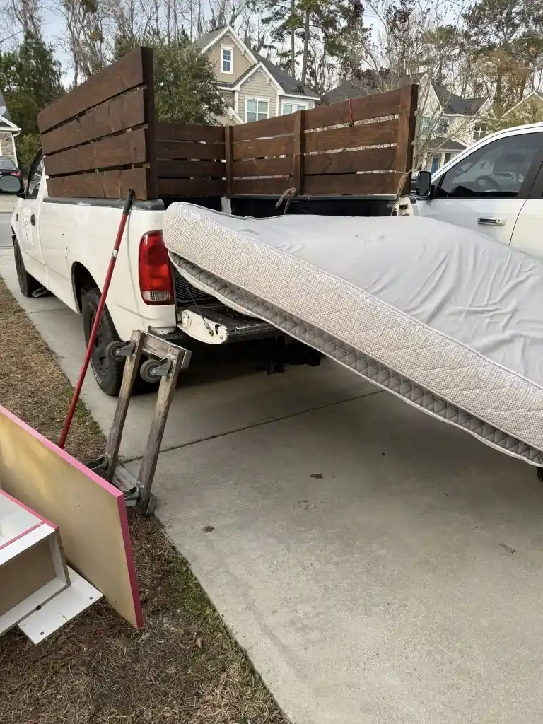 Book your junk removal plan in Lubbock with a mattress and household items loaded in a pickup truck